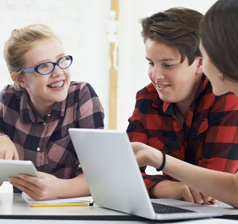 two students looking at laptop